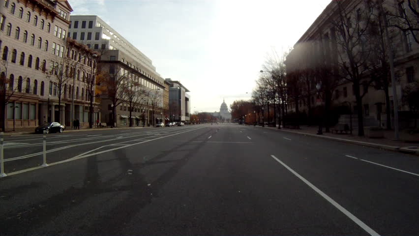 A handheld shot driving towards the U.S. Capitol Building in Washington DC on a cloudy afternoon. | Shutterstock HD Video #9778871