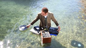 funky dj in a suit plays in the sea
