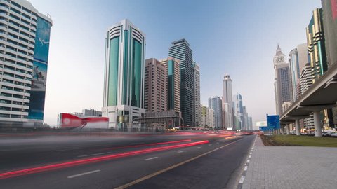 Skyscrapers at the Sheikh Zayed Road from day to night transition with traffic and lighhs torn on in Dubai timelapse hyperlapse at twilight 4K