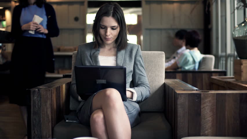 Beautiful businesswoman working on laptop by the chair in cafe
 | Shutterstock HD Video #9792815