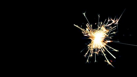 Sparkler burning from right to left in center of black background.  Recorded in 4K at 24fps.  Post-processing and tints applied.