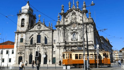 PORTO PORTUGAL MARCH 2015;Old tram passing in front of the Carmelitas church in Porto Portugal. 4K