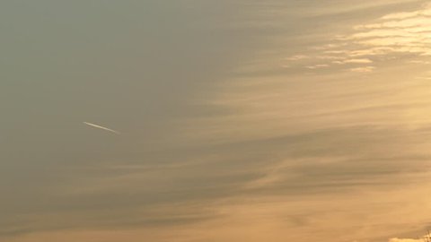 Montreal, Canada - August 2014 - 4K UHD - Chemtrail produced by airplane flying high at sunset