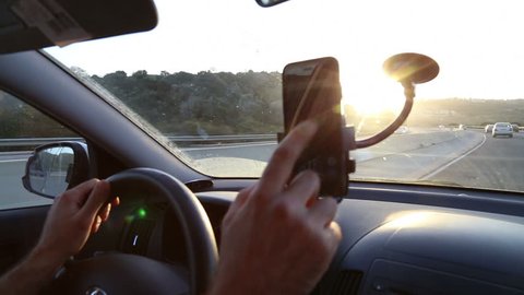 TEL-AVIV - APRIL 19, 2015: Using phone while driving 