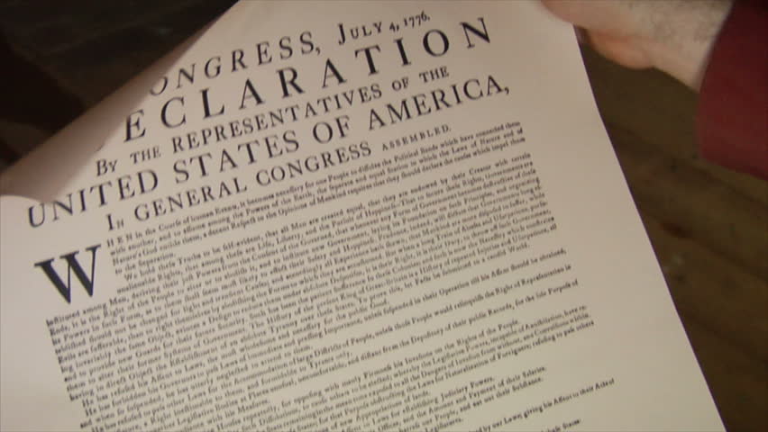 PHILADELPHIA - JULY 1776 -- Reenactor, Re-enactment of Colonial American patriot, Sons of Liberty, with Declaration of Independence during American Revolution. Giving speech, reading the document.