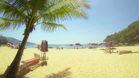 FullHD video - Bright sun in an azure sky. over a bold. blue. tropical sea. with white sand cooled by a refreshing breeze on the island of Phuket in southern Thailand.