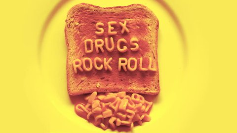 sex drugs rock n roll written with spaghetti pasta letters in tomato sauce on toast
