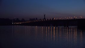 Kiev, Ukraine. Night Time Lapse of Right Bank of Kiev and Road Bridge - Paton Bridge under the River Dnepr at Evening. 4K Ultra HD 3840x2160 Video Clip