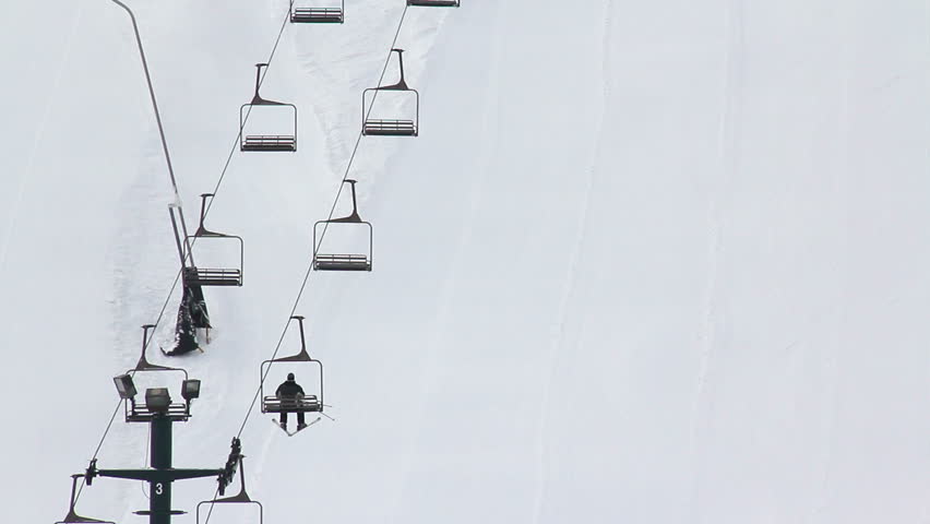 Skiers ride a skit lift to the top of the mountain.