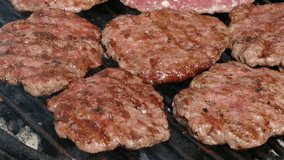Barbecue, preparing hamburger on classical way cook turning meat, 4K video