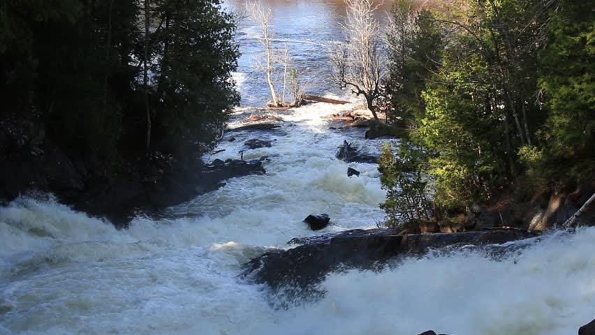 Oxtongue River - Ragged Falls Provincial Park, water of waterfall roaring and pouring down cliff in Algonquin Highland near Algonquin Park Ontario Canada