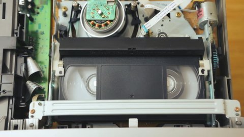rewind of magnetic videotape in the VCR mechanism.The sequence of video footage. magnetic videotape in the VCR mechanism. Videorecorder S-VHS, VHS