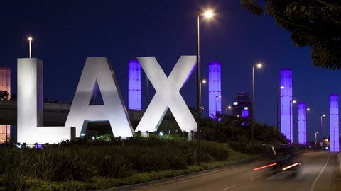 LOS ANGELES, CA, USA - APR 15, 2015: 4K Time lapse of LAX Sign at Los Angeles airport at twilight with traffic light trails