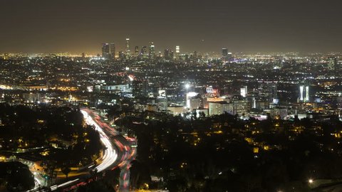 LOS ANGELES, CA, USA - APR 15, 2015: 4K Time lapse zoom out of Downtown Los Angeles from Hollywood Hills with Interstate 101 in the foreground during the evening rush hour