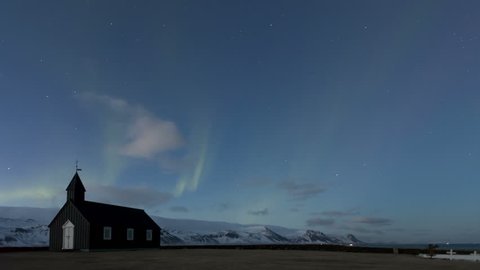 4K Time lapse of dramatic Northern Lights Aurora Borealis dancing over the Black Church of Budir in Iceland
