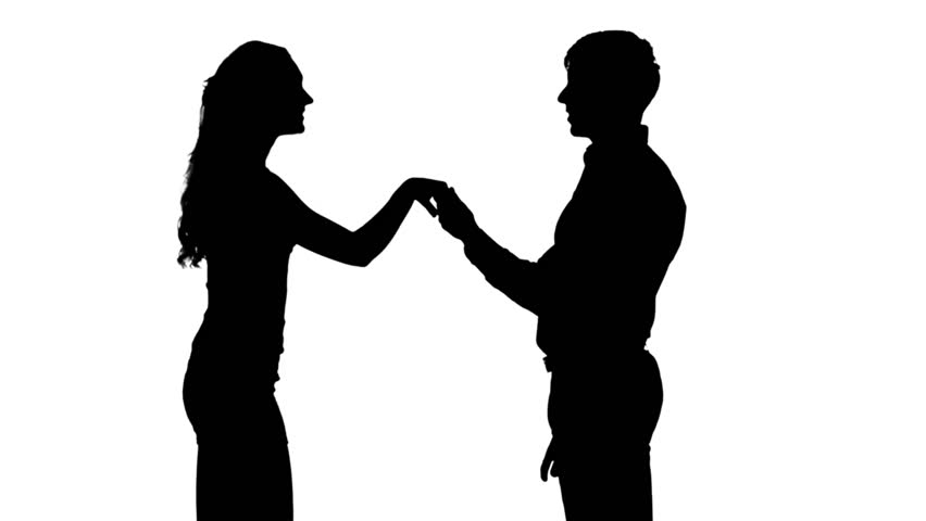 Silhouette of man kissing woman