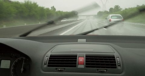Driving fast on rainy highway POV. Shot in 4k format