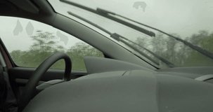 Driving fast on damaged highway under heavy rain POV. Shot in 4k format