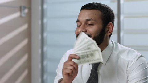 Man rejoices money. Manager enjoying  dollars. Clerk sniffing new money.