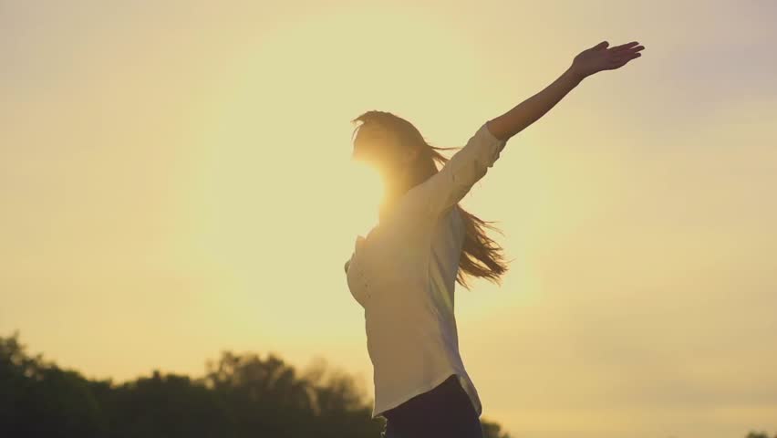 Attractive young woman silhouette dancing outdoors on a sunset with sun shining bright behind her on a horizon. Slow motion, shot at 240 fps. | Shutterstock HD Video #9875954