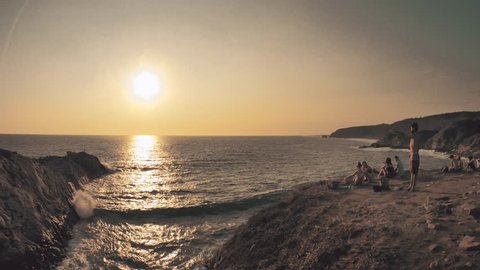 People contemplating panoramic view after enjoying the sun falling on the pacific ocean. 4k