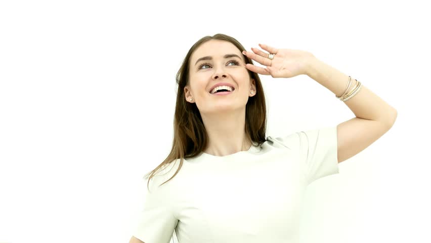 Happy woman posing on white wall