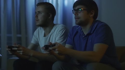 Friends are Playing Video Games at Nights. Shot on RED Cinema Camera in 4K (UHD).