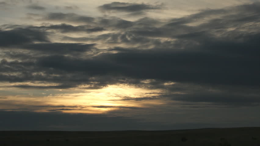 A beautiful sun shows itself from behind clouds on an overcast morning in