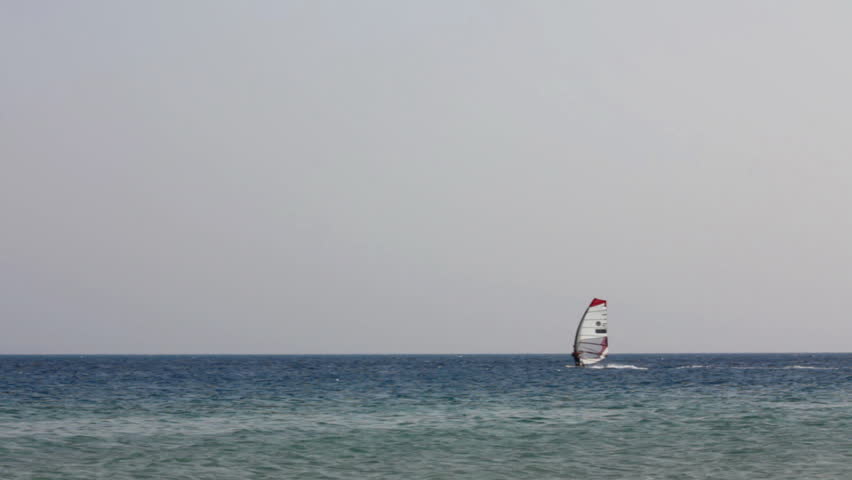 windsurfing - surfers on blue sea surface