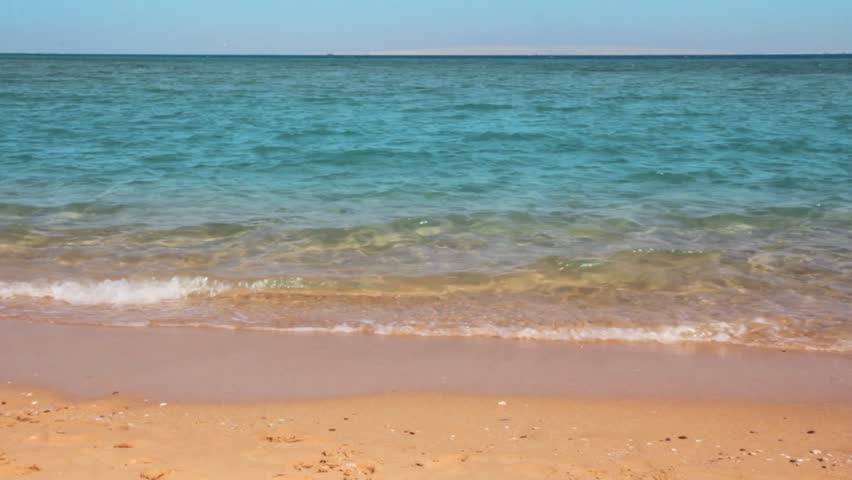 turquoise sea water waves and sand beach