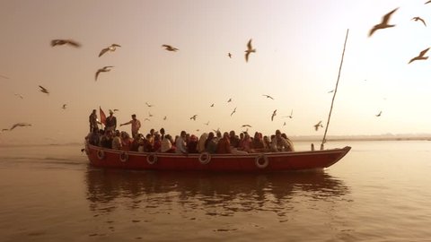 Tourist Boat and Seagulls, Ganges River, Varanasi, India, february 2015.Indian tourists taking the popular boat tour on the sacred Ganges river in Varanasi. 