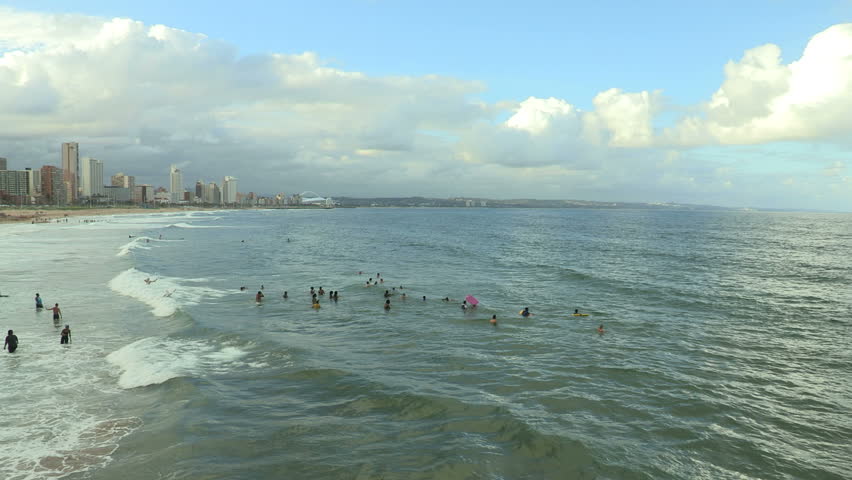 Late afternoon bathers at Durban beach