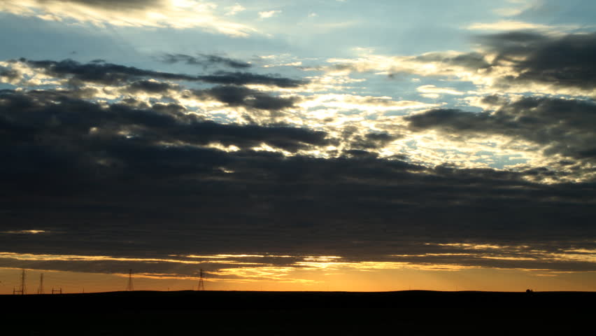 Amazing sunrise behind clouds in the summer in eastern Colorado. HD 1080p time