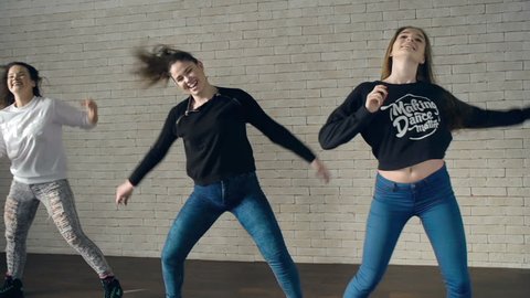 Shaky camera of three girls performing dancehall combination