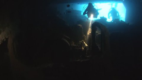 RED SEA, STRAIT OF GUBAL, EGYPT - OCTOBER, 2014:  Diver inspects the cargo in the hold of the wreck SS Thistlegorm, Red Sea, Sharm el Sheikh, Egypt, Sinai

