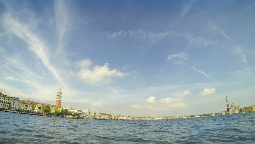 Sunny day skyline with boat traffic on San Marco basin in Venice, Italy. San Marcos bell tower, Doges palace at left and San Giorgio Maggiore church at right. Time-lapse view from Punta della dogana.