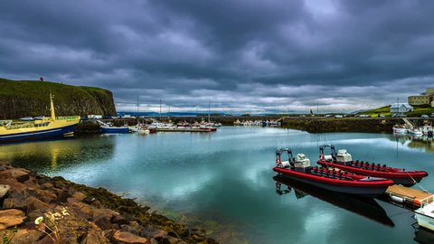 Stykkishólmur Harbour, Iceland - 15 June 2015: The water in the port reflects floating clouds. 4K TimeLapse Redaktionel stock-video