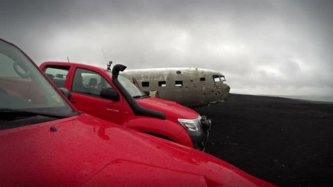 Iceland - 15 June 2015: Off-road vehicles (Super trucks) and US military aircraft crashed in 1971 near the black beach and Reynisdrangar. 4K TimeLapse