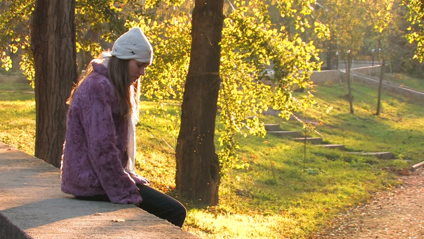 Pretty young Woman in Park on autumn sunny day 