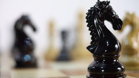 Chess Board and Pieces. Black Queen takes White King. Move Queen. Closeup. Shallow depth of field. Dolly shot. Follow focus