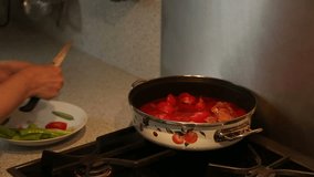 Serial videos of a housewife cooking  beef in a cooker with tomatoes and green pepper 