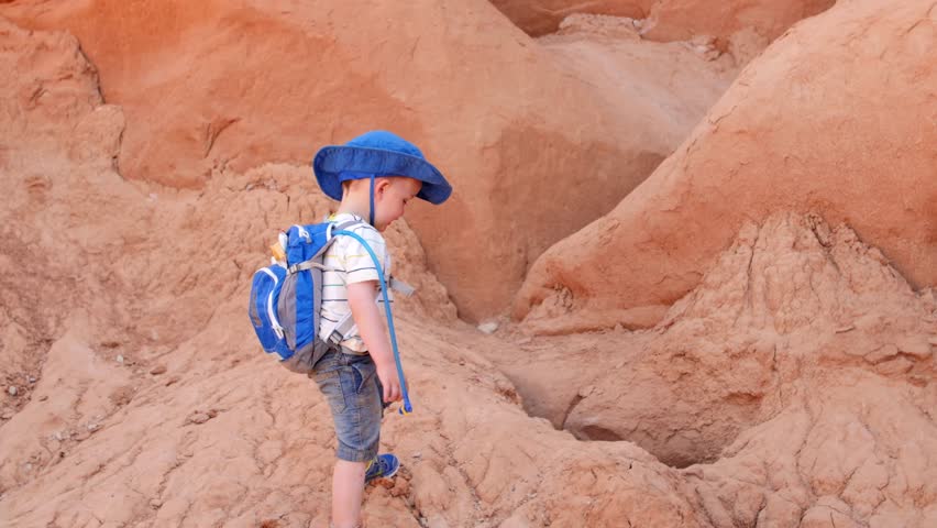 Families and kids walking through the rock formations of Goblin Valley State Park in Southern Utah.