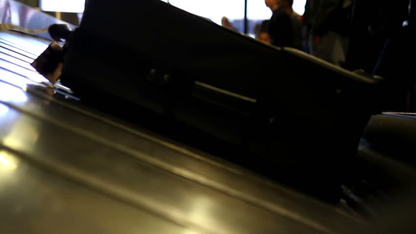 Close-up of a luggage conveyor belt at an airport.