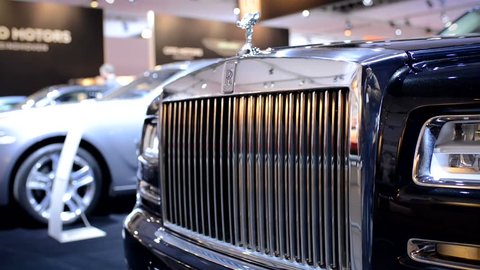 AMSTERDAM, THE NETHERLANDS - APRIL 16, 2015: Rolls Royce Ghost front grille with the Spirit of Ecstasy on top at the motor show. The camera is sliding from right to left.