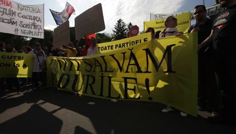 BUCHAREST, ROMANIA - MAY 9, 2015: Thousands of Romanians protest against mass logging of forests in Romania, blaming politicians for allowing deforestation of the important European woodlands.
