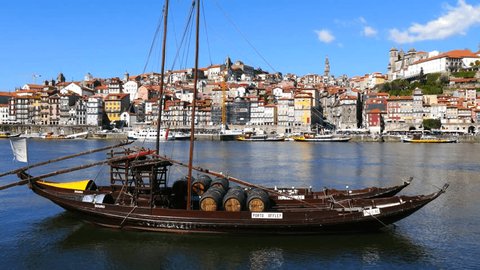 Porto Portugal March 2015 .Douro river and traditional boats with wine barrels in Porto, Portugal. 4K