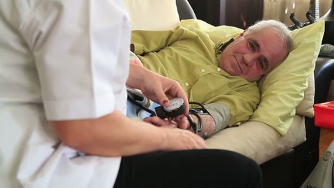 Female doctor checking  blood pressure