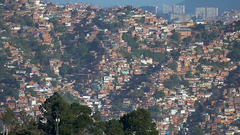 Panning view of a shanty town residential district in Caracas City, Venezuela. Poorness is a main factor for drug dealing and crime in these places and a common factor in developing counties. 