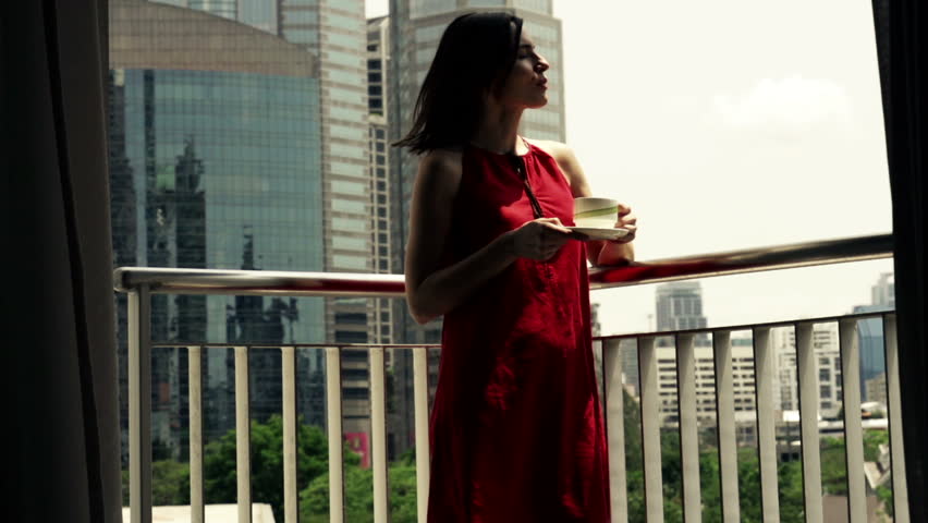 Young woman enjoying view on the terrace in the city,slow motion shot at 240fps
