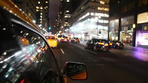 Yellow taxi driving through Manhattan in New York
